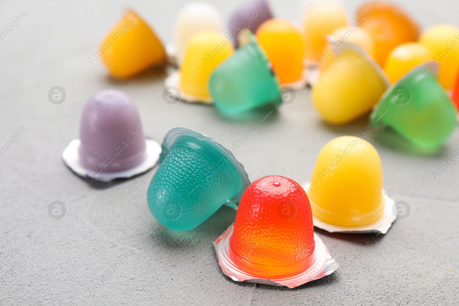 Photo of Tasty bright jelly cups on light table