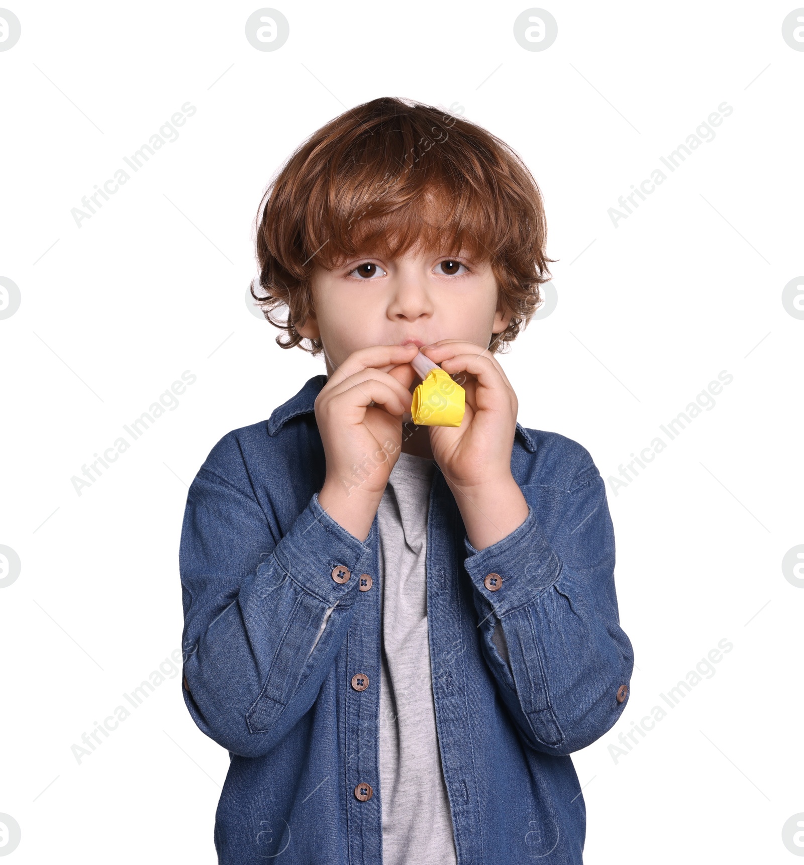 Photo of Birthday celebration. Cute little boy with blower on white background