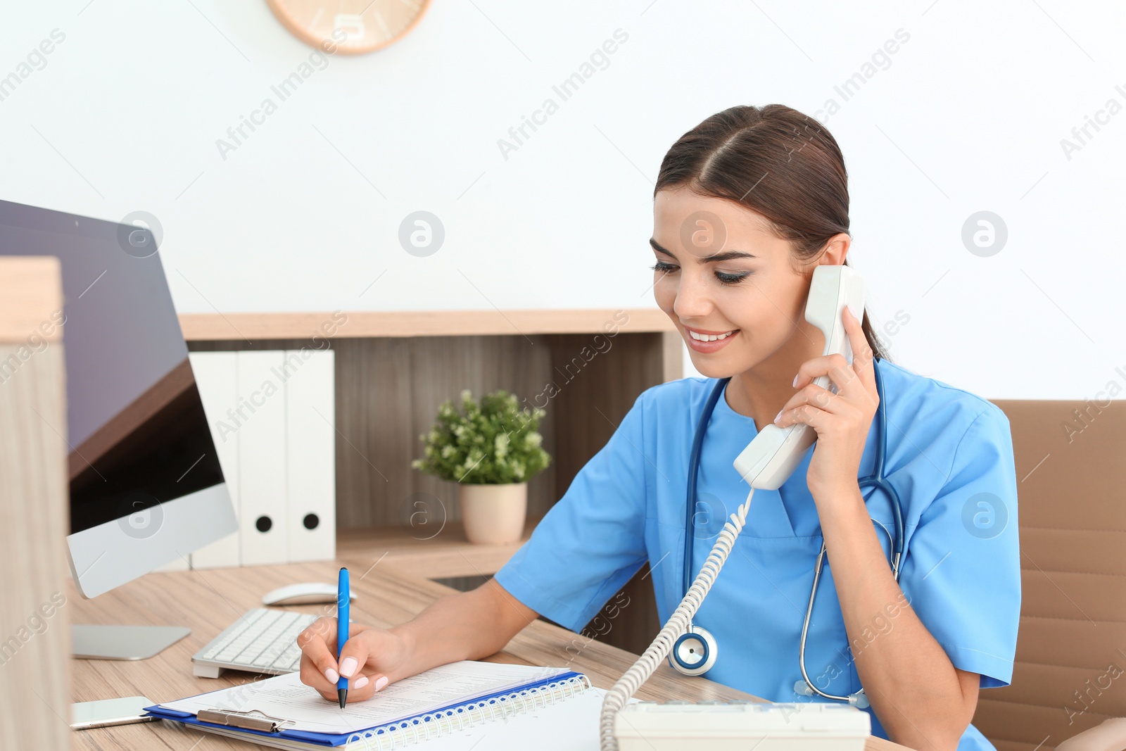 Photo of Female medical assistant at workplace in clinic. Health care service