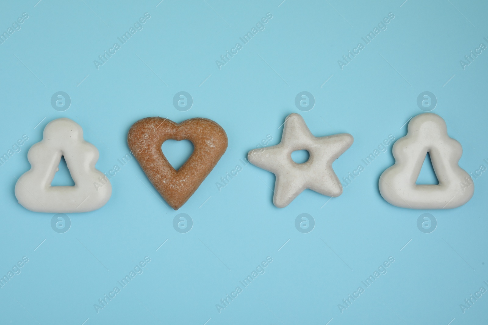 Photo of Tasty homemade cookies on light blue background, flat lay