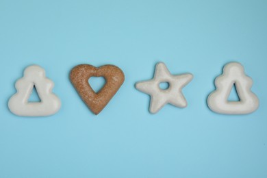 Photo of Tasty homemade cookies on light blue background, flat lay