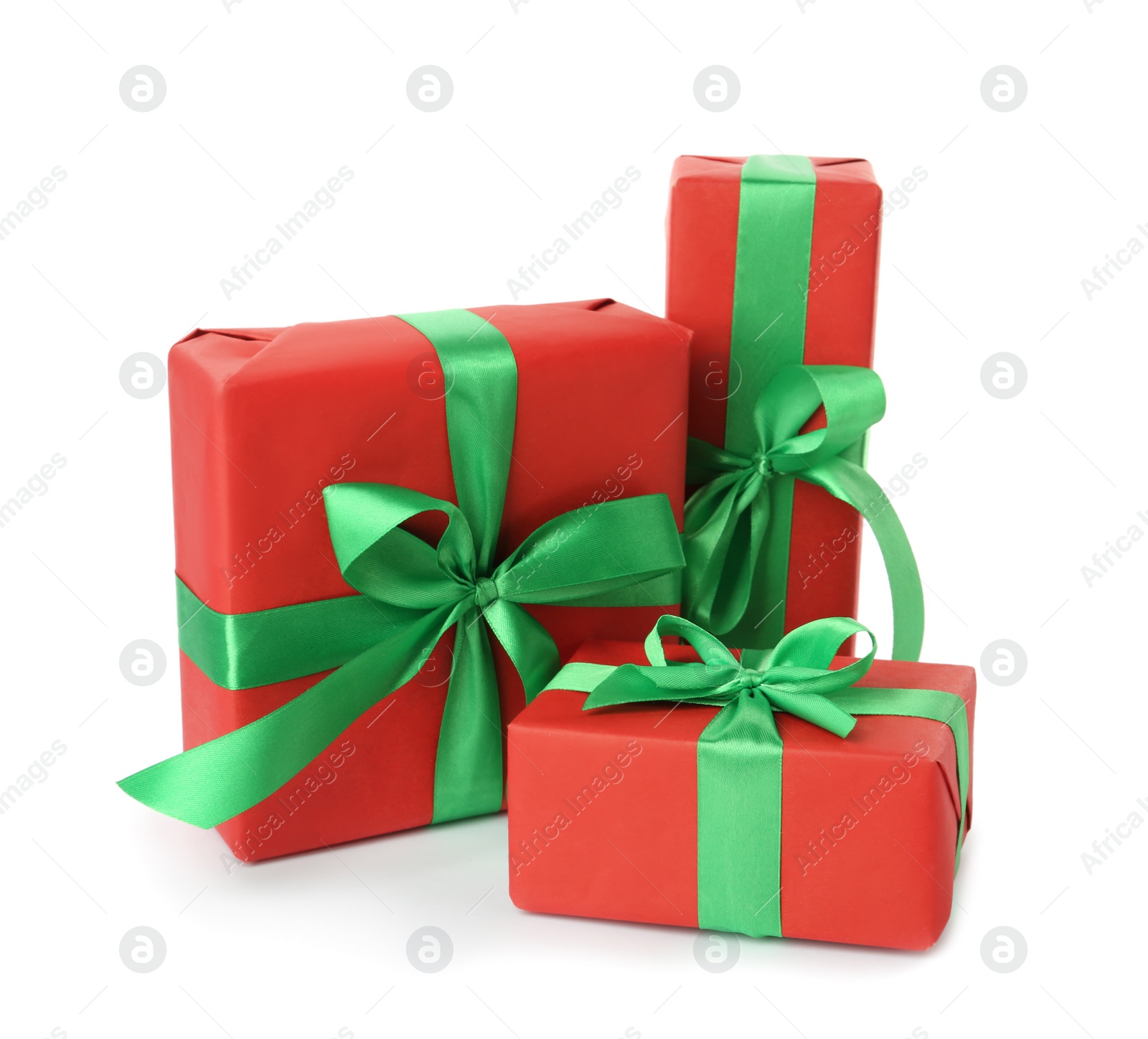 Photo of Red gift boxes with green bows on white background
