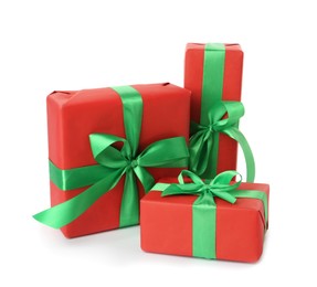 Photo of Red gift boxes with green bows on white background