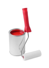 Photo of Can of red paint and roller on white background