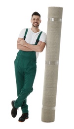 Photo of Male worker with rolled carpet on white background