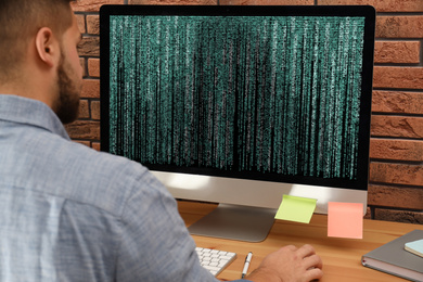 Professional programmer working with computer in office, closeup