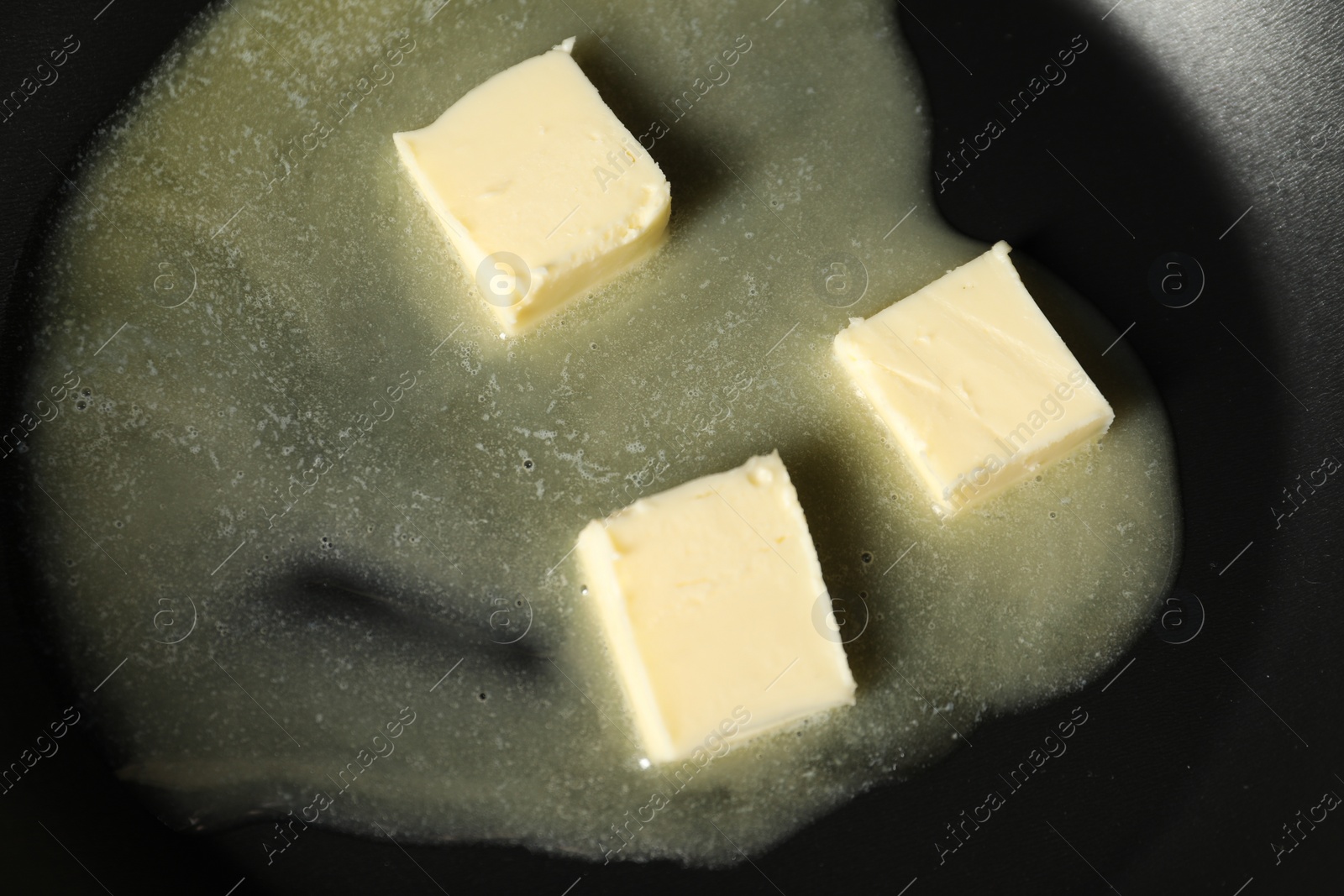 Photo of Melting butter in frying pan, top view