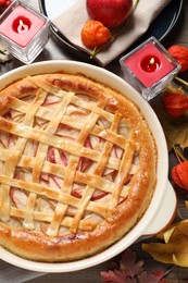Photo of Delicious homemade apple pie and autumn decor on wooden table, flat lay. Thanksgiving Day celebration