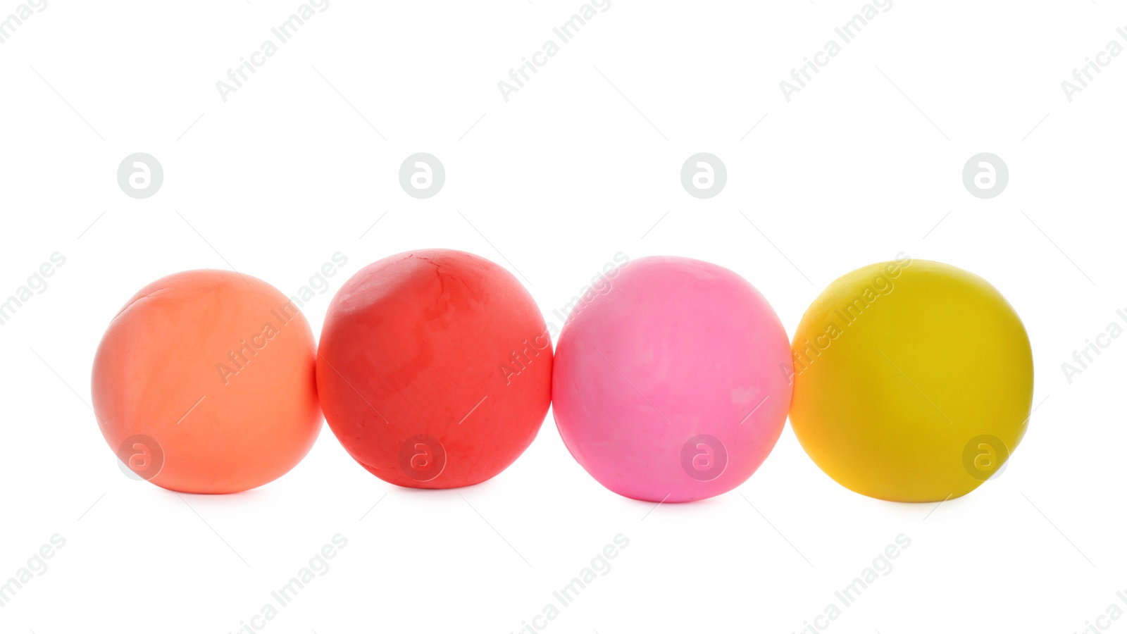 Photo of Row of color play dough balls isolated on white