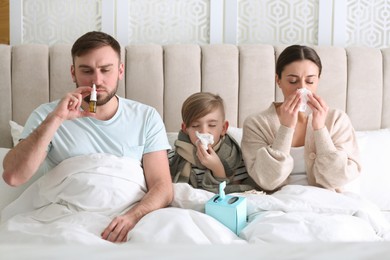 Photo of Family suffering from runny nose in bed at home