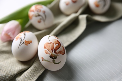 Photo of Beautifully painted Easter eggs on plate, closeup. Space for text