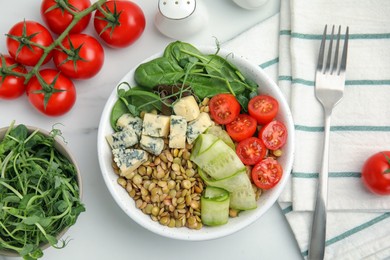 Photo of Delicious lentil bowl with blue cheese, tomatoes and cucumber on white marble table, flat lay