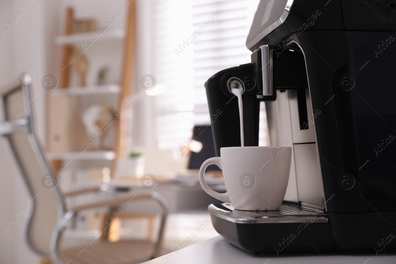 Photo of Modern coffee machine pouring milk into cup in office. Space for text