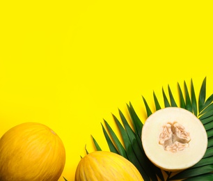 Photo of Composition with ripe tasty melons on yellow background, flat lay. Space for text