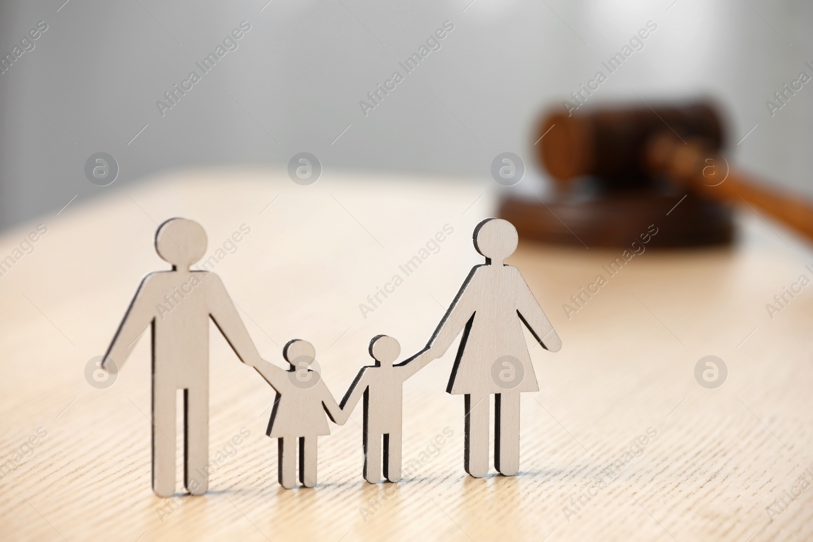 Photo of Family law. Figure of parents with children and gavel on wooden table, space for text