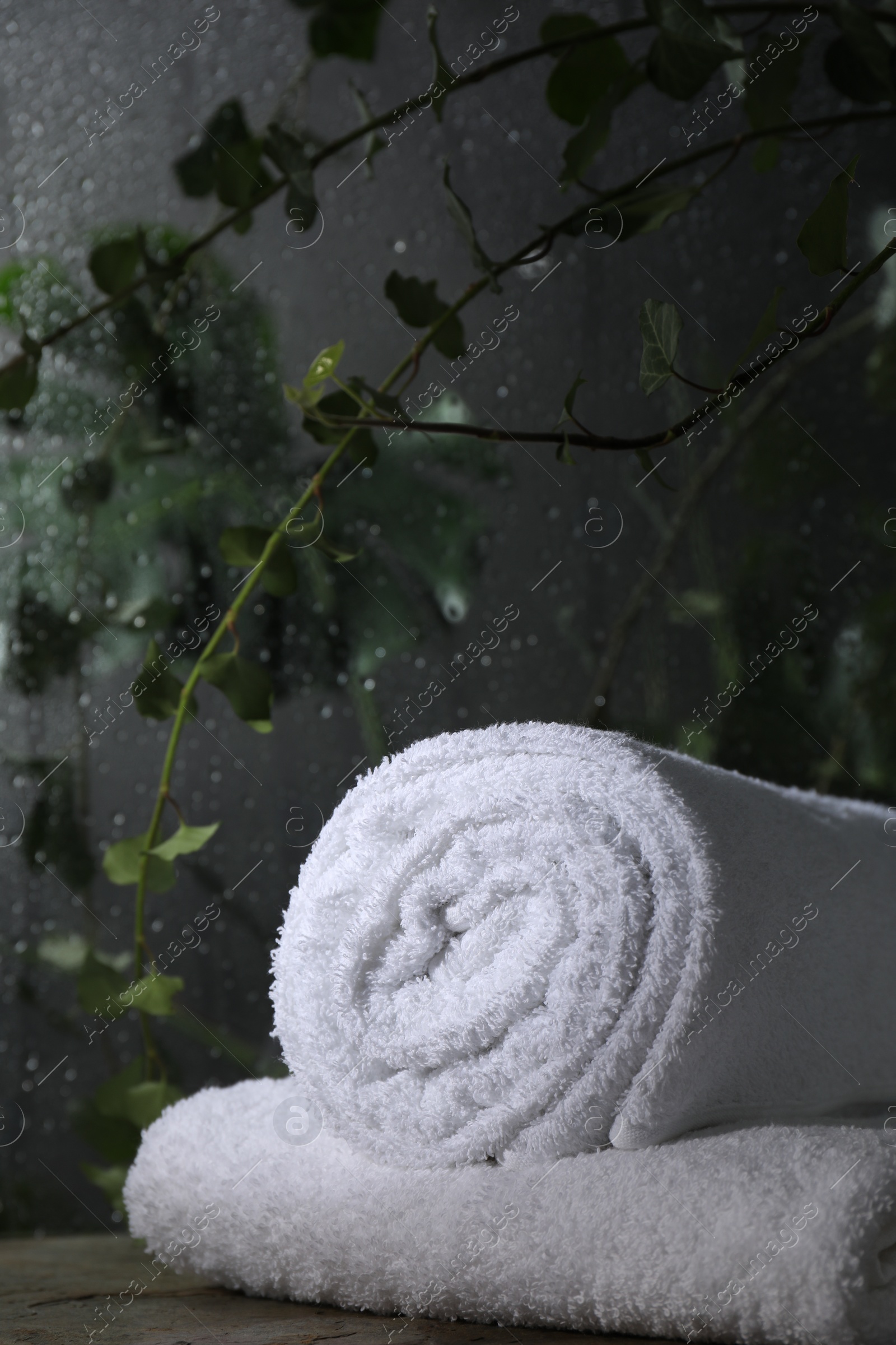 Photo of White terry towels on table in bathroom