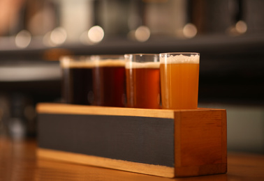 Photo of Beer tasting set on wooden bar counter