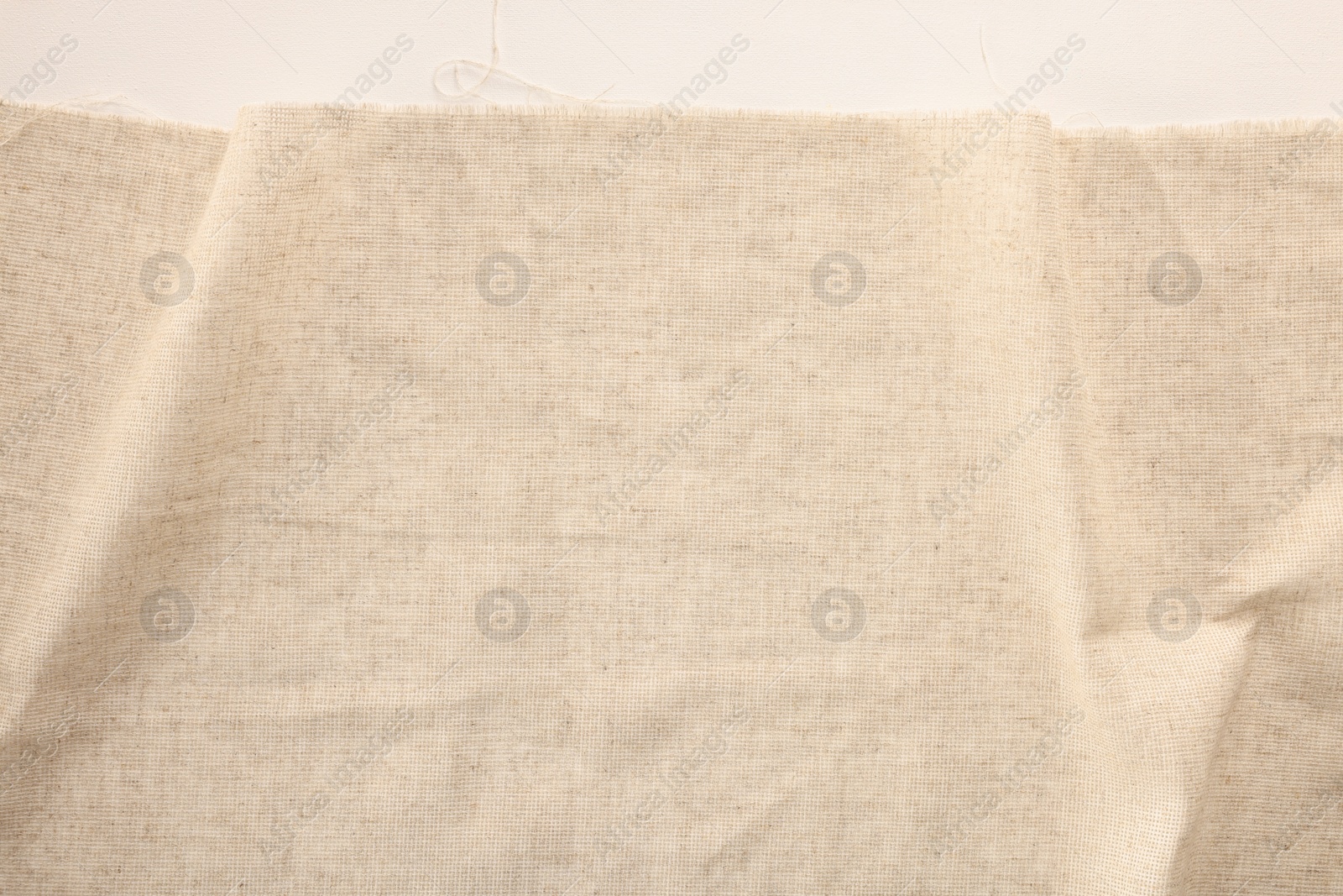 Photo of Natural burlap fabric on white background, top view