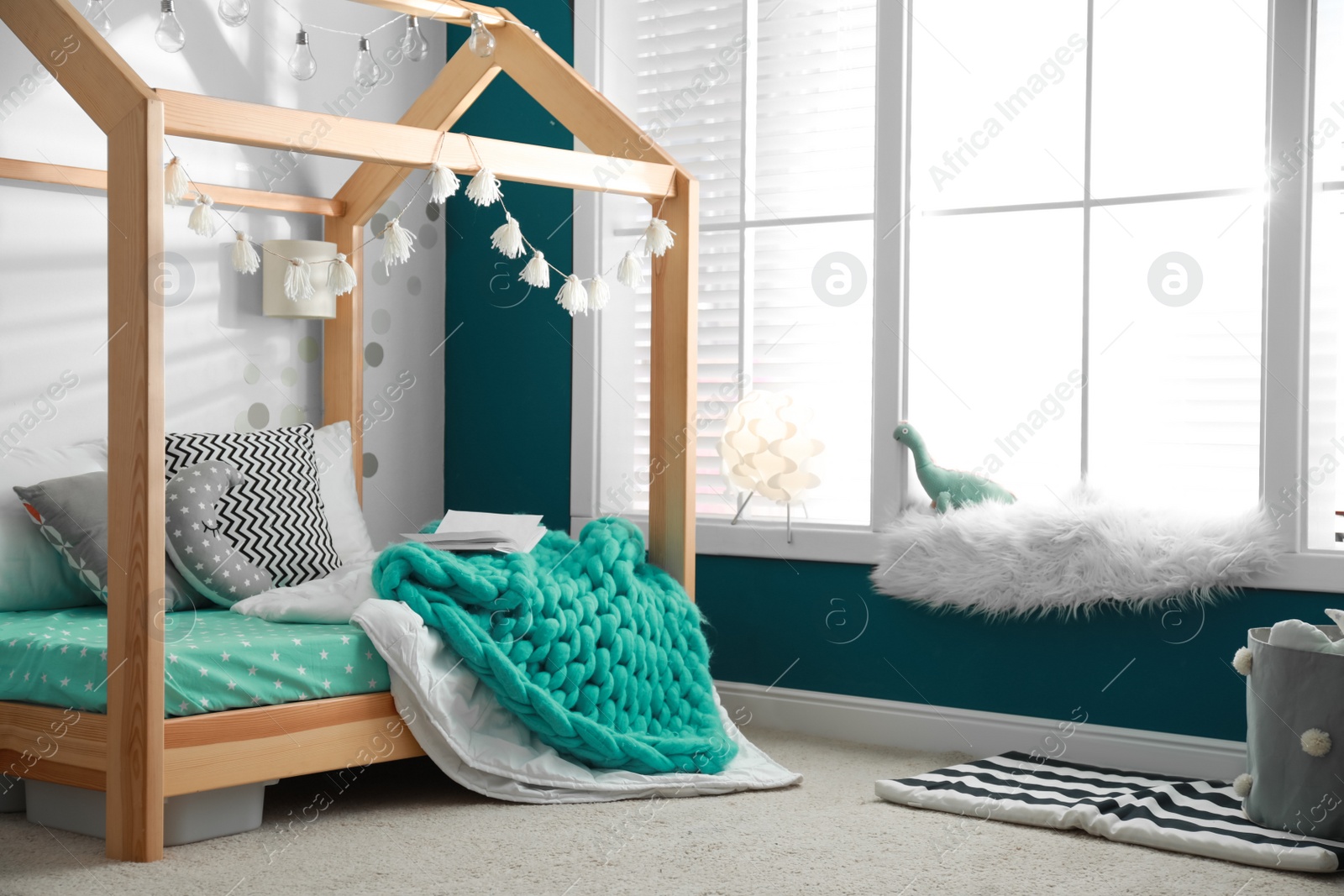 Photo of Cozy child room interior with comfortable bed