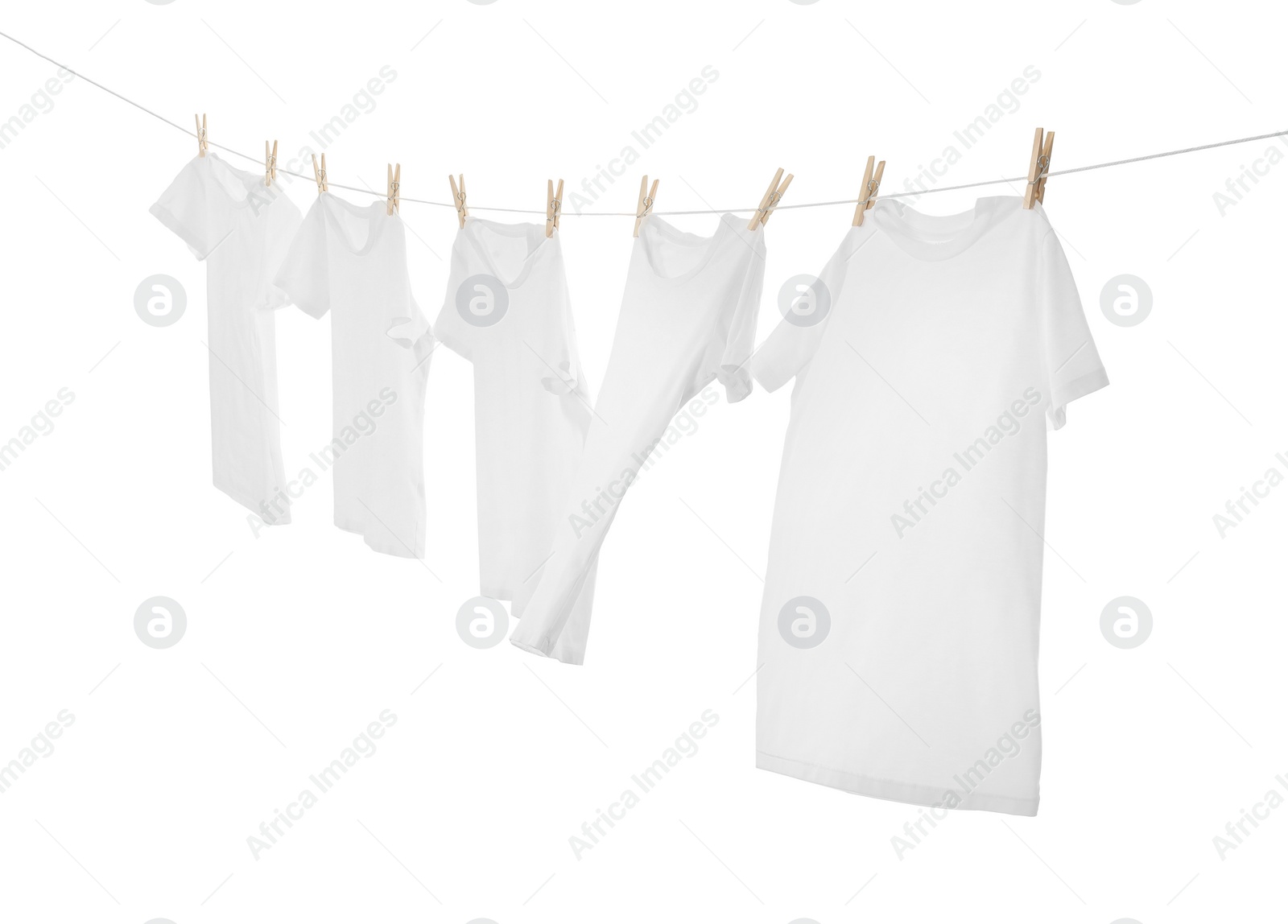 Photo of Many t-shirts drying on washing line isolated on white