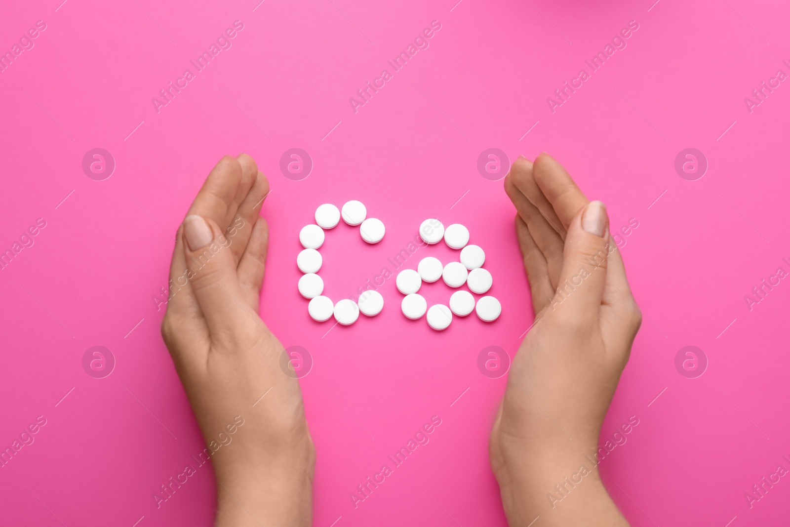 Photo of Woman with calcium symbol made of white pills on pink background, top view