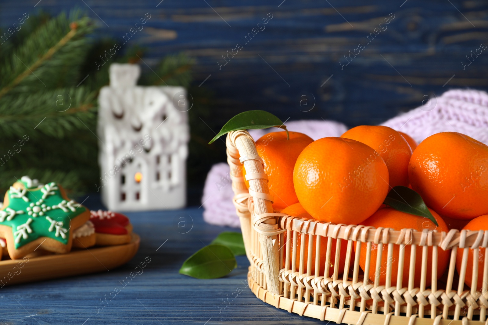 Photo of Tasty fresh tangerines on blue wooden table. Christmas celebration