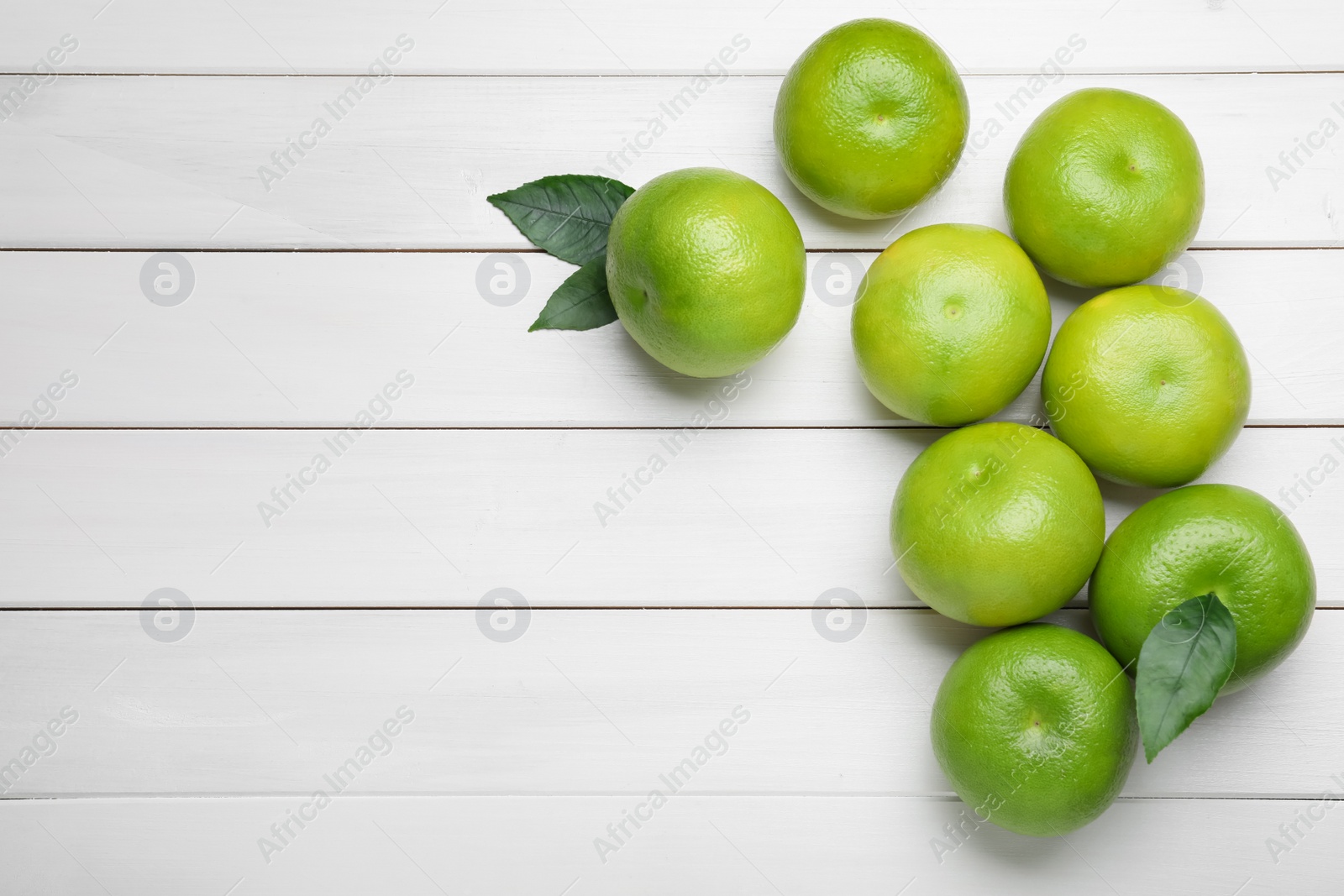 Photo of Fresh ripe sweeties on white wooden table, flat lay. Space for text
