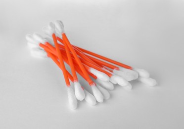 Photo of Heap of clean cotton buds on white background