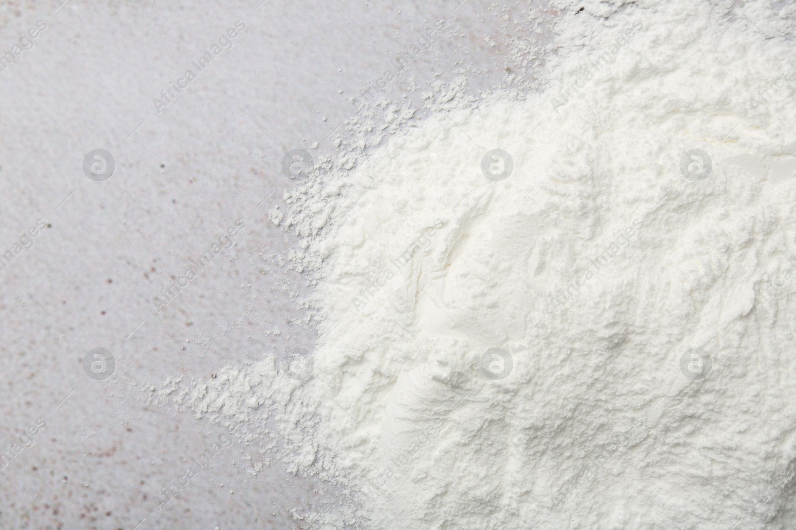 Photo of Baking powder on light textured table, top view. Space for text