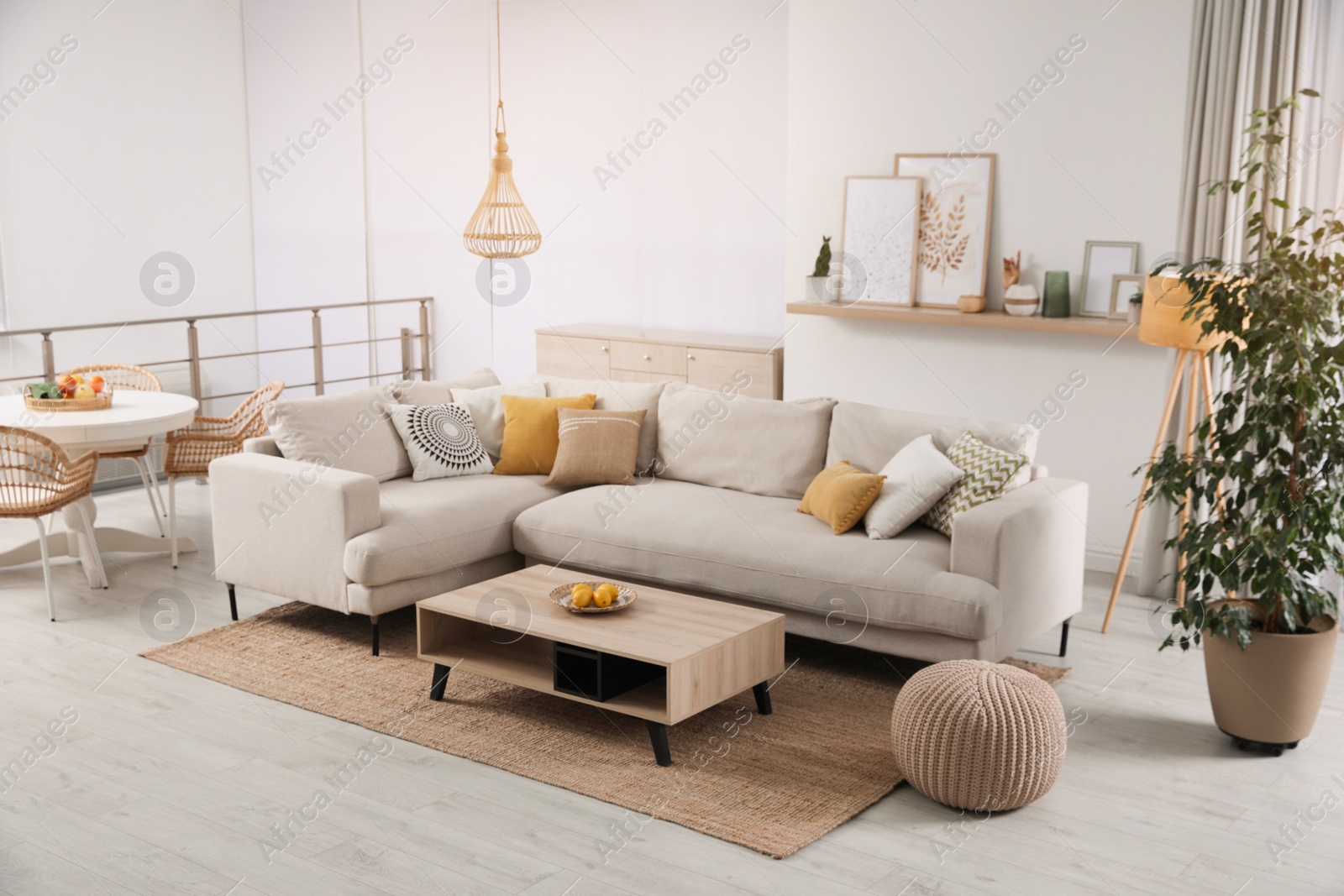 Photo of Stylish living room interior with comfortable grey sofa and coffee table