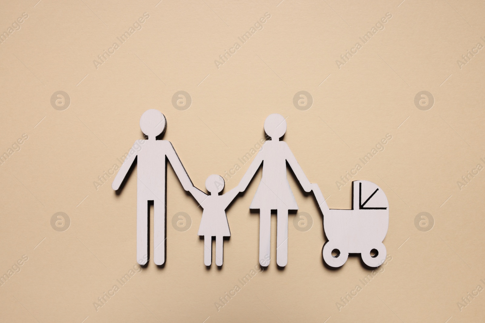 Photo of Figures of family on beige background, top view. Insurance concept