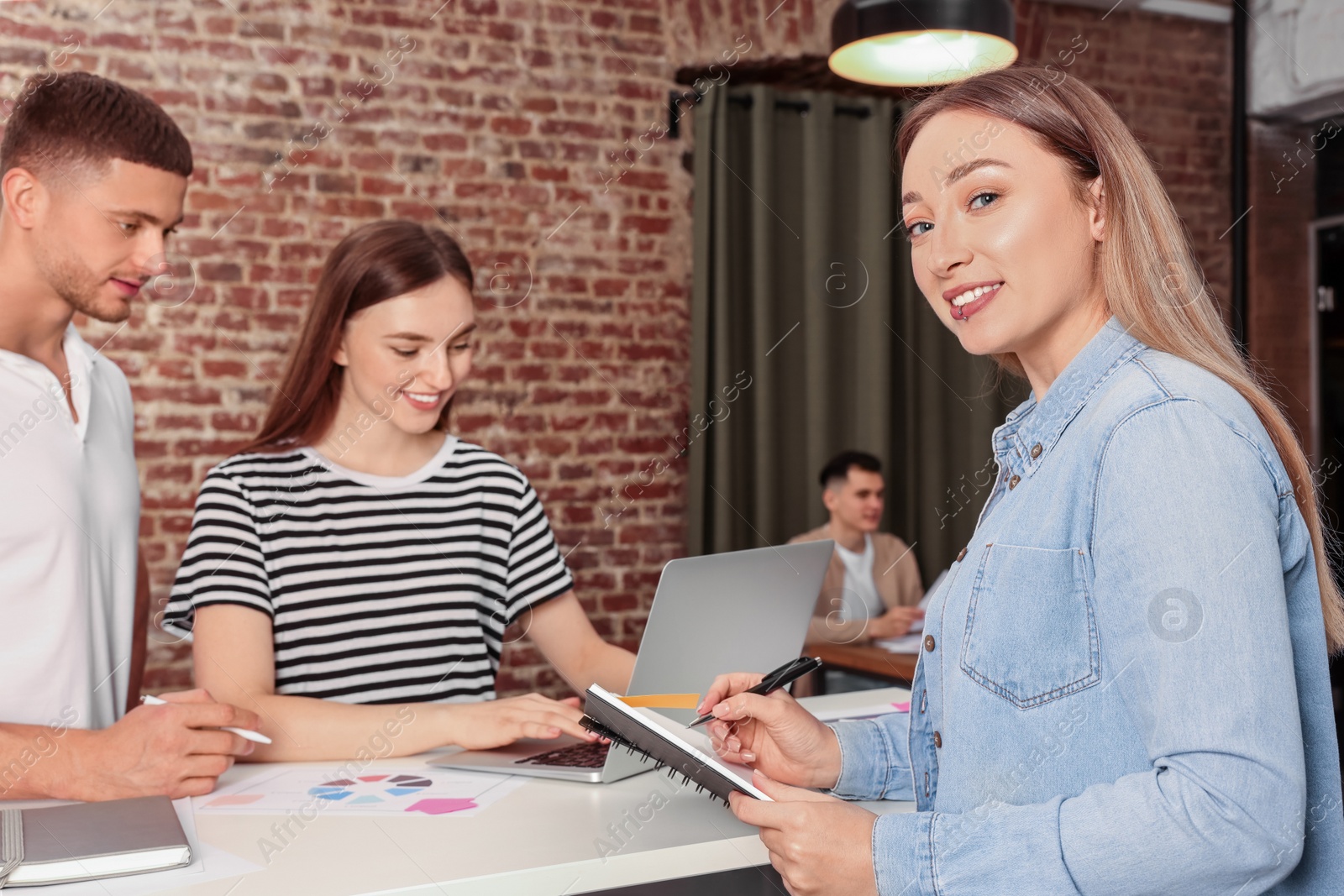 Photo of Team of employees working together in office