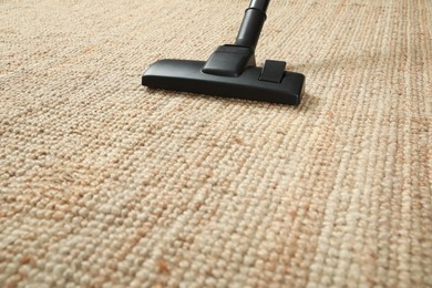 Removing dirt from beige carpet with modern vacuum cleaner. Space for text