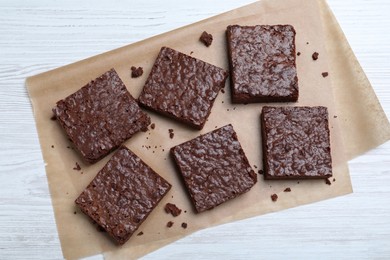 Photo of Delicious chocolate brownies on white wooden table, top view