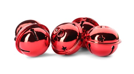 Photo of Shiny red sleigh bells on white background
