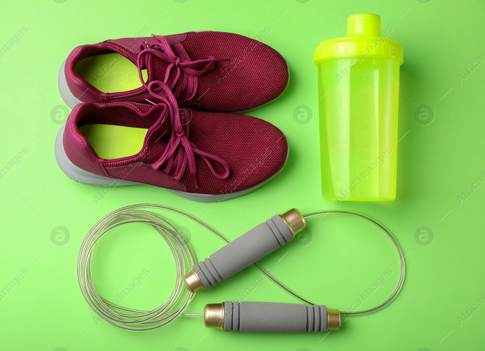 Photo of Flat lay composition with jump rope on color background