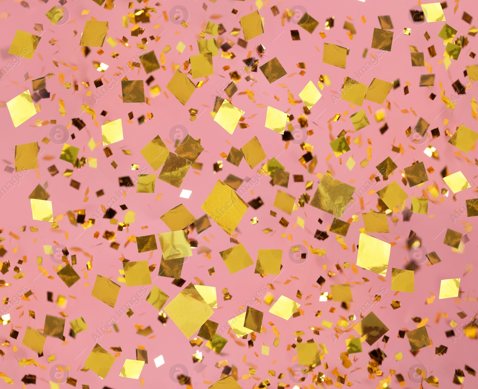 Image of Shiny golden confetti falling down on pink background