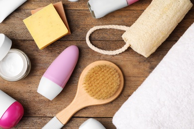 Photo of Flat lay composition with natural deodorants and bath accessories on wooden table