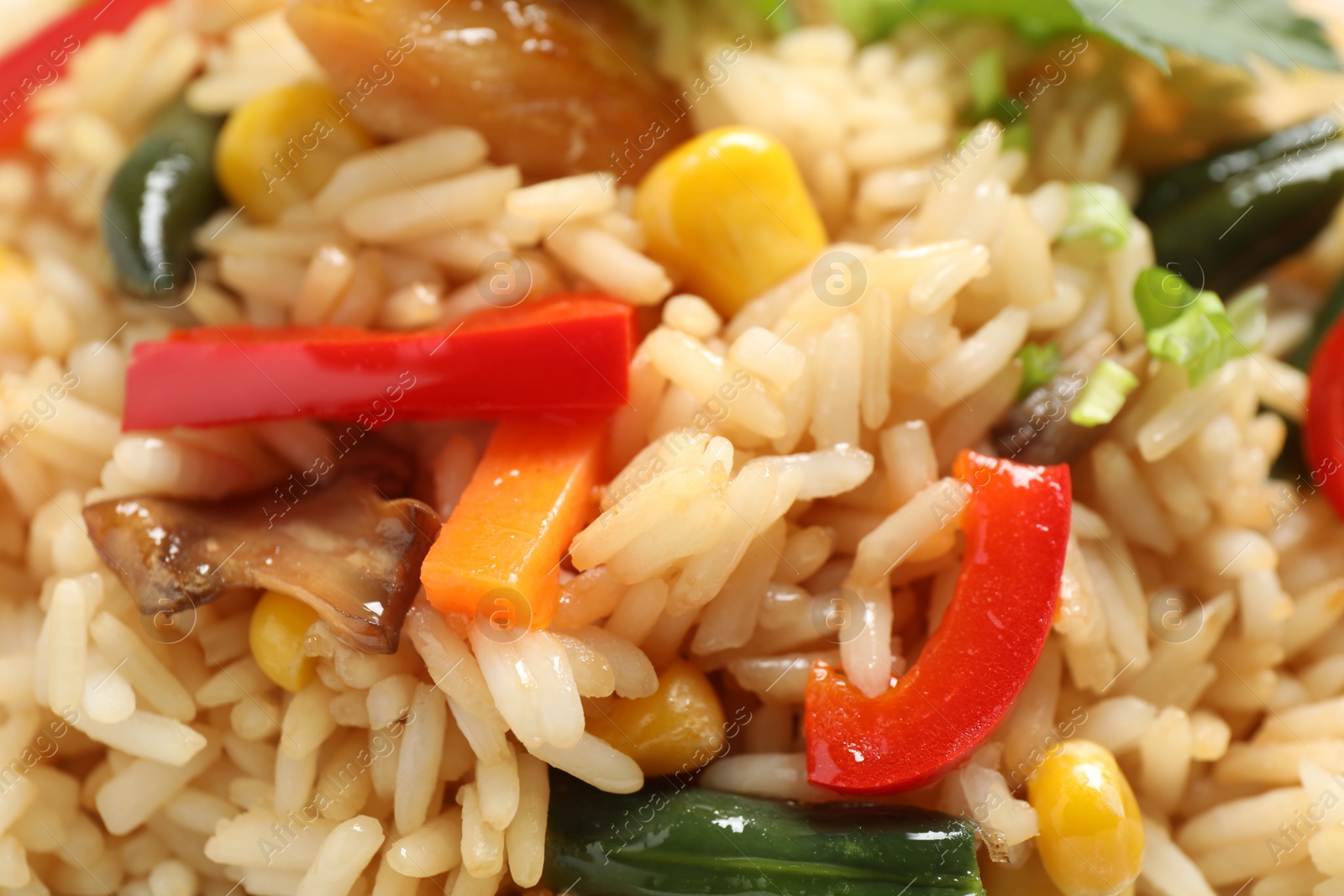 Photo of Delicious rice pilaf with vegetables as background, closeup