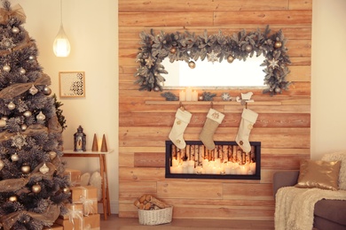 Beautiful Christmas interior of living room with decorative fireplace