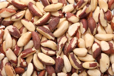 Photo of Many delicious Brazil nuts as background, top view