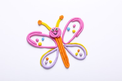 Butterfly made of plasticine on white background, top view