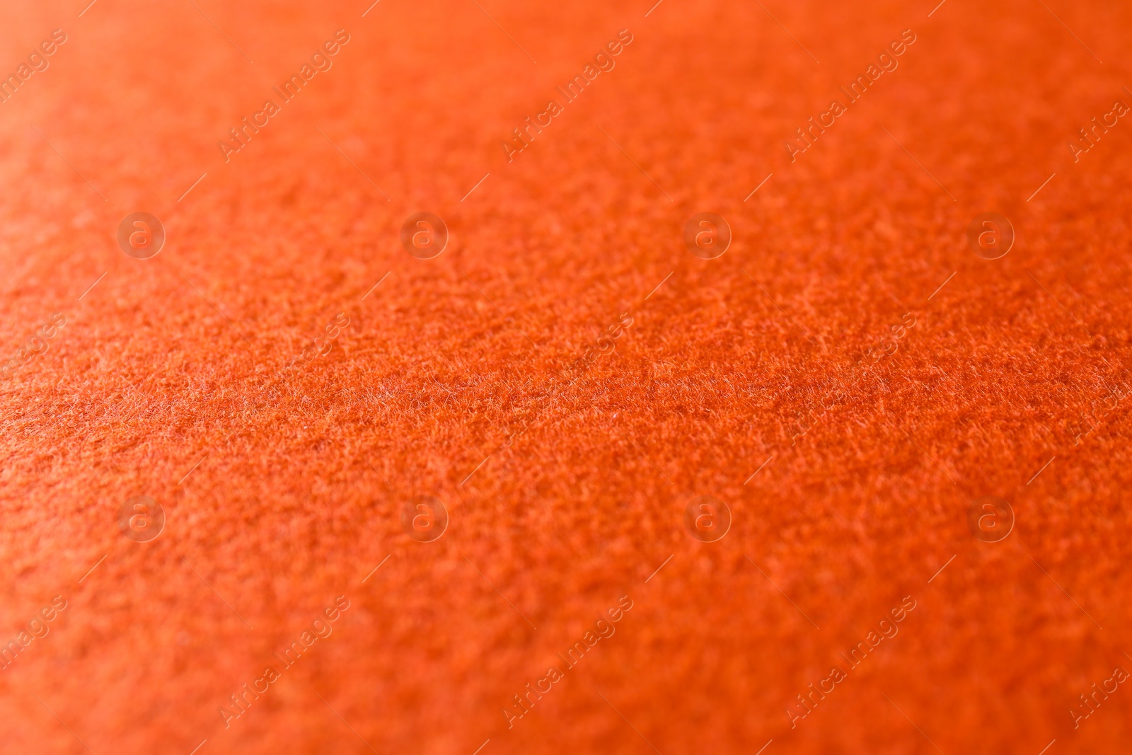 Photo of Orange textured surface as background, closeup view