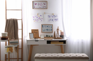 Photo of Stylish room interior with creative workplace near white wall