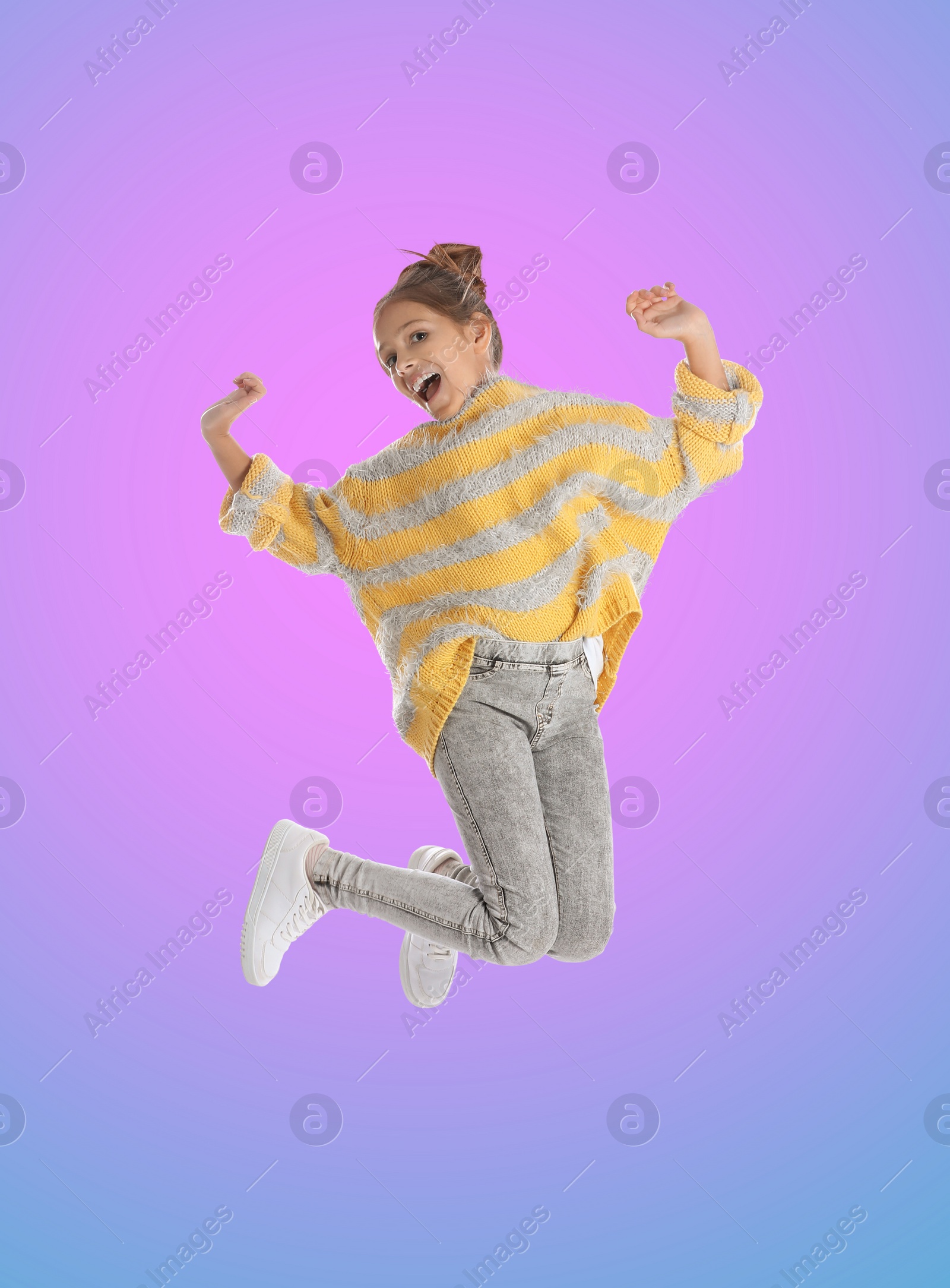 Image of Happy cute girl jumping on color gradient background