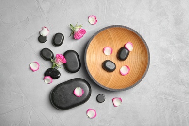 Photo of Flat lay composition with spa stones on grey background