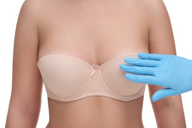 Mammologist checking woman's breast on white background, closeup