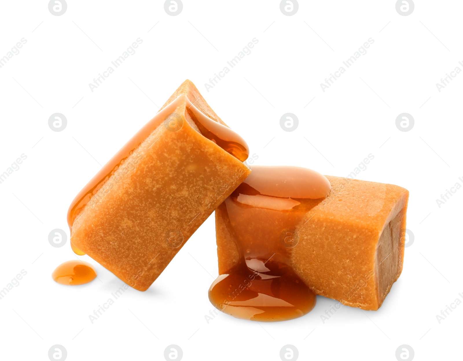 Photo of Delicious candies with caramel sauce on white background