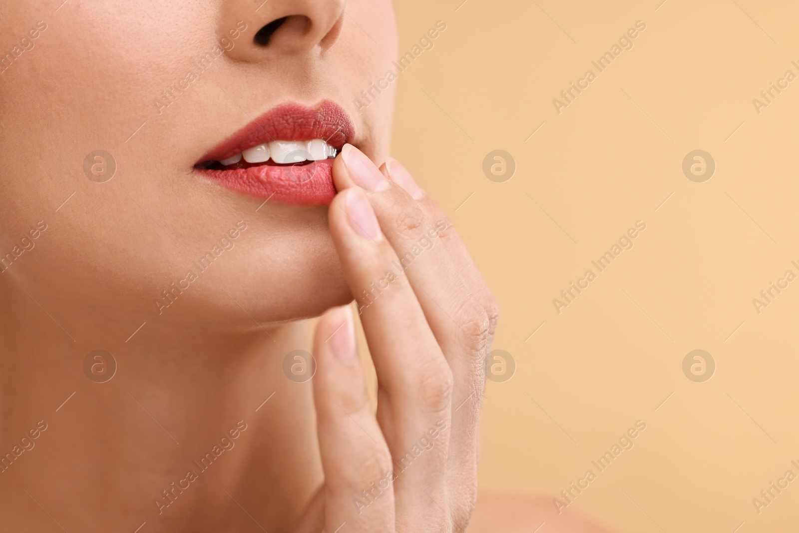 Photo of Woman with beautiful lips on beige background, closeup. Space for text