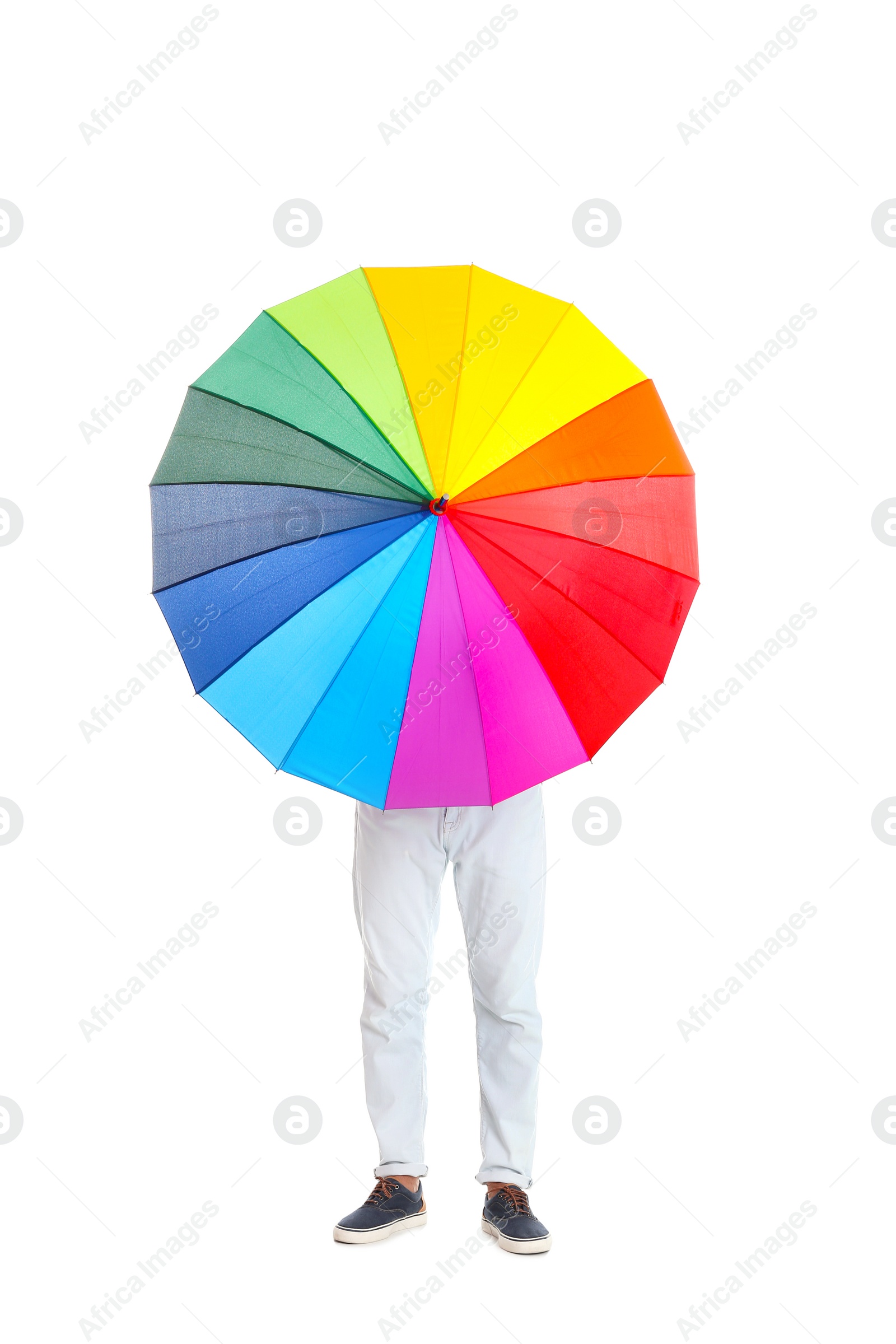 Photo of Man hiding behind rainbow umbrella on white background